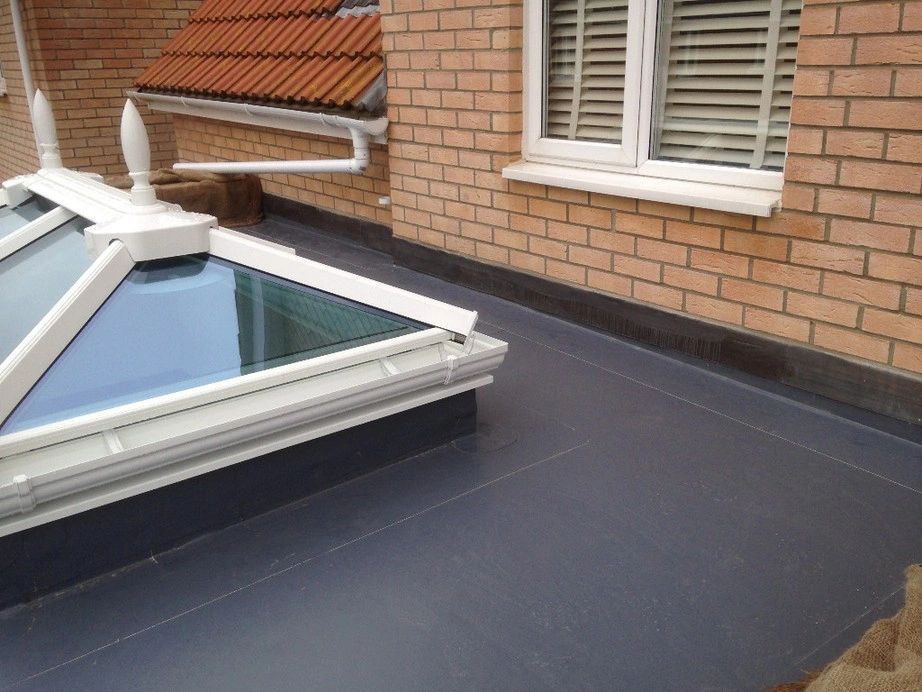 Rubber roofing installation with skylight